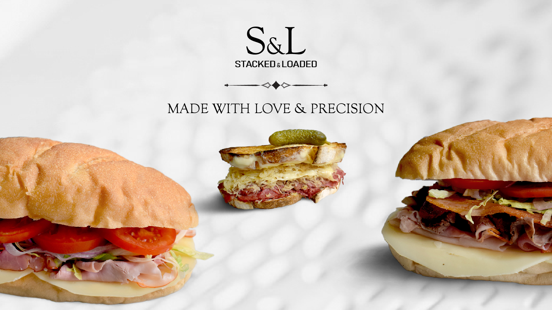 Stacked sandwiches on white background with Stacked and Loaded logo and title stating Made with Love & Precision
